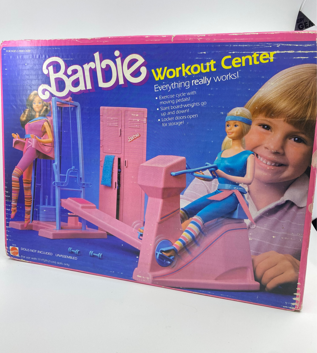 Box of Barbie Workout Center toy set with images of dolls and exercise equipment.