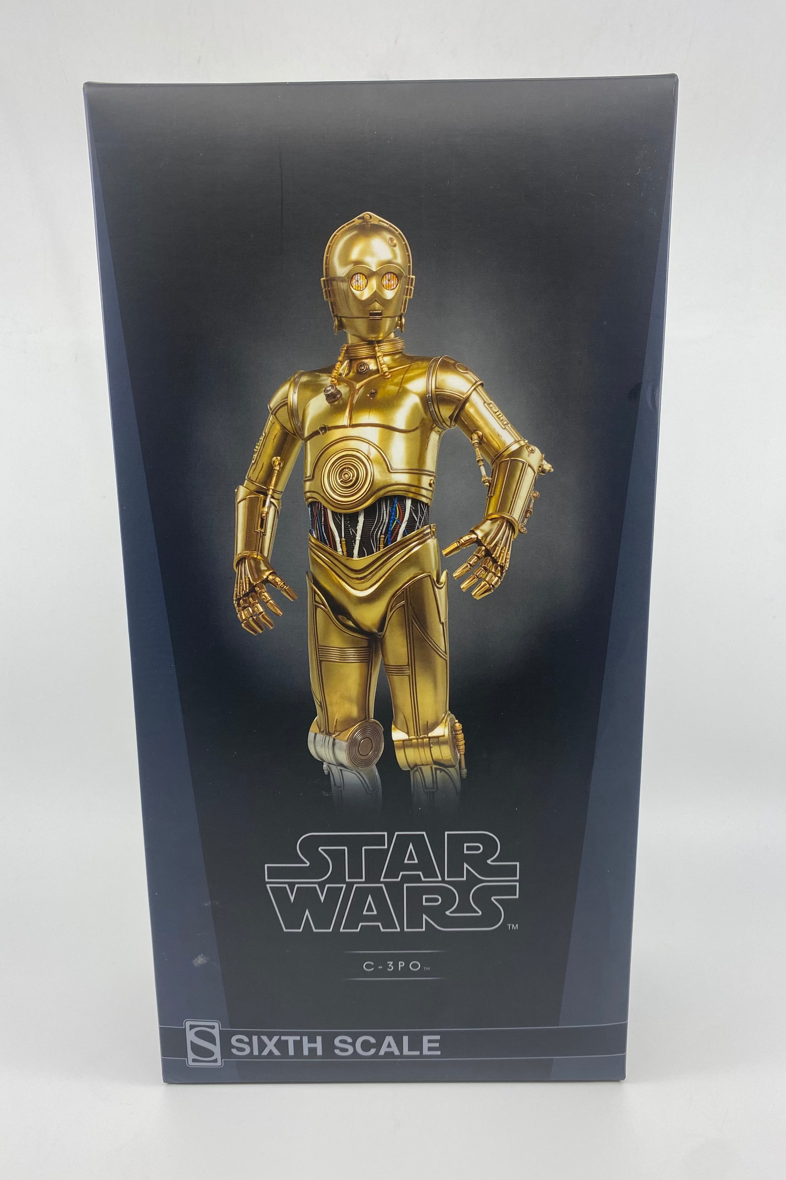 Gold robot figure on a black stand with 'Star Wars' branding