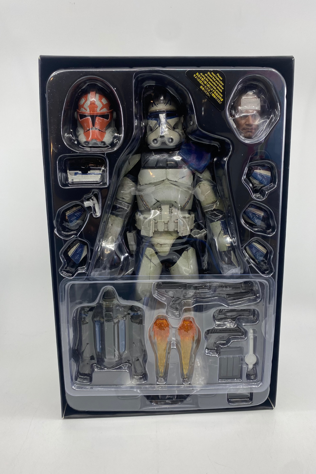 Action figure in packaging with clear window on a white background