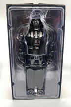 Toy figure of a character in a clear plastic packaging on a white background