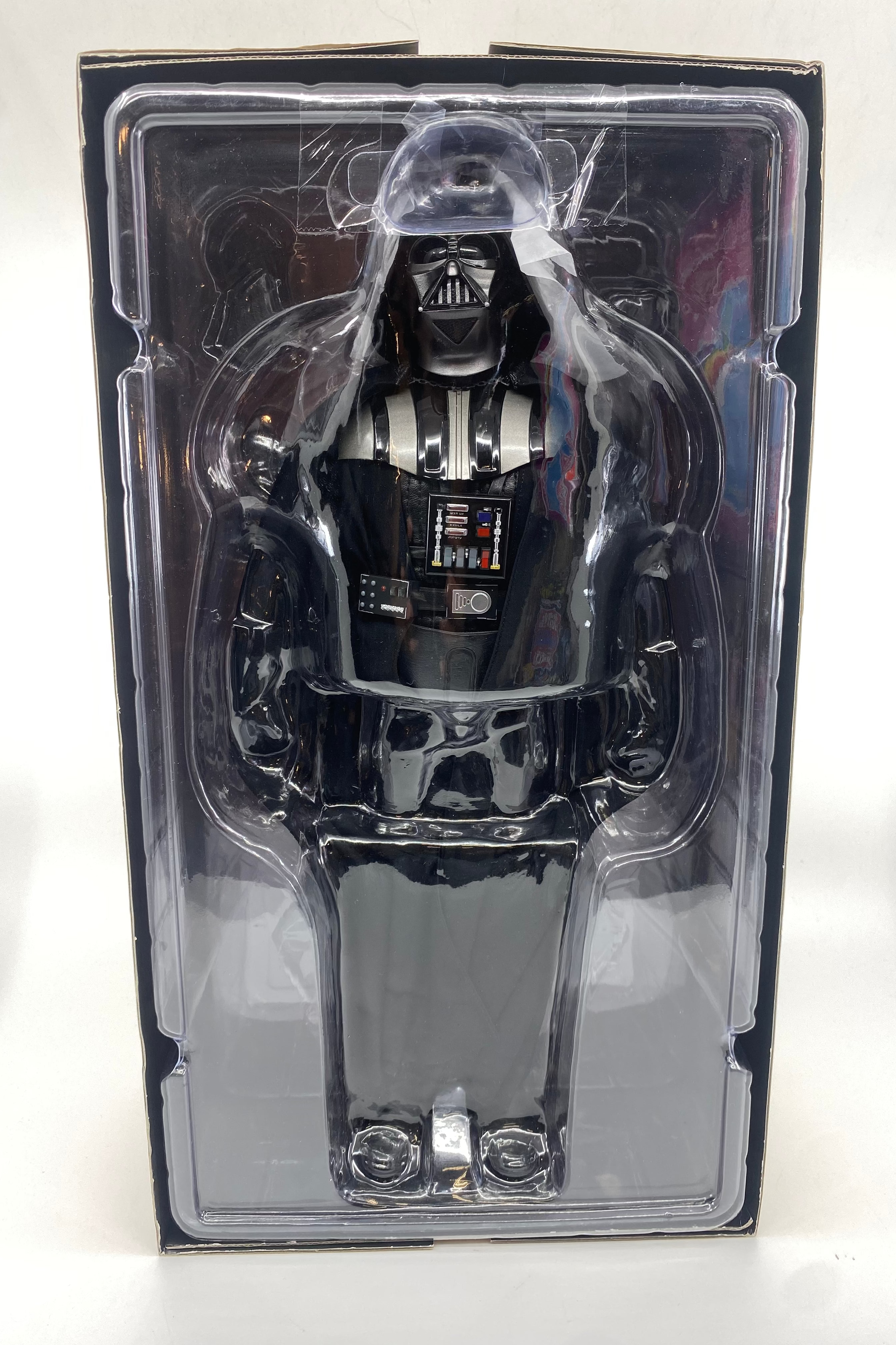 Toy figure of a character in a clear plastic packaging on a white background