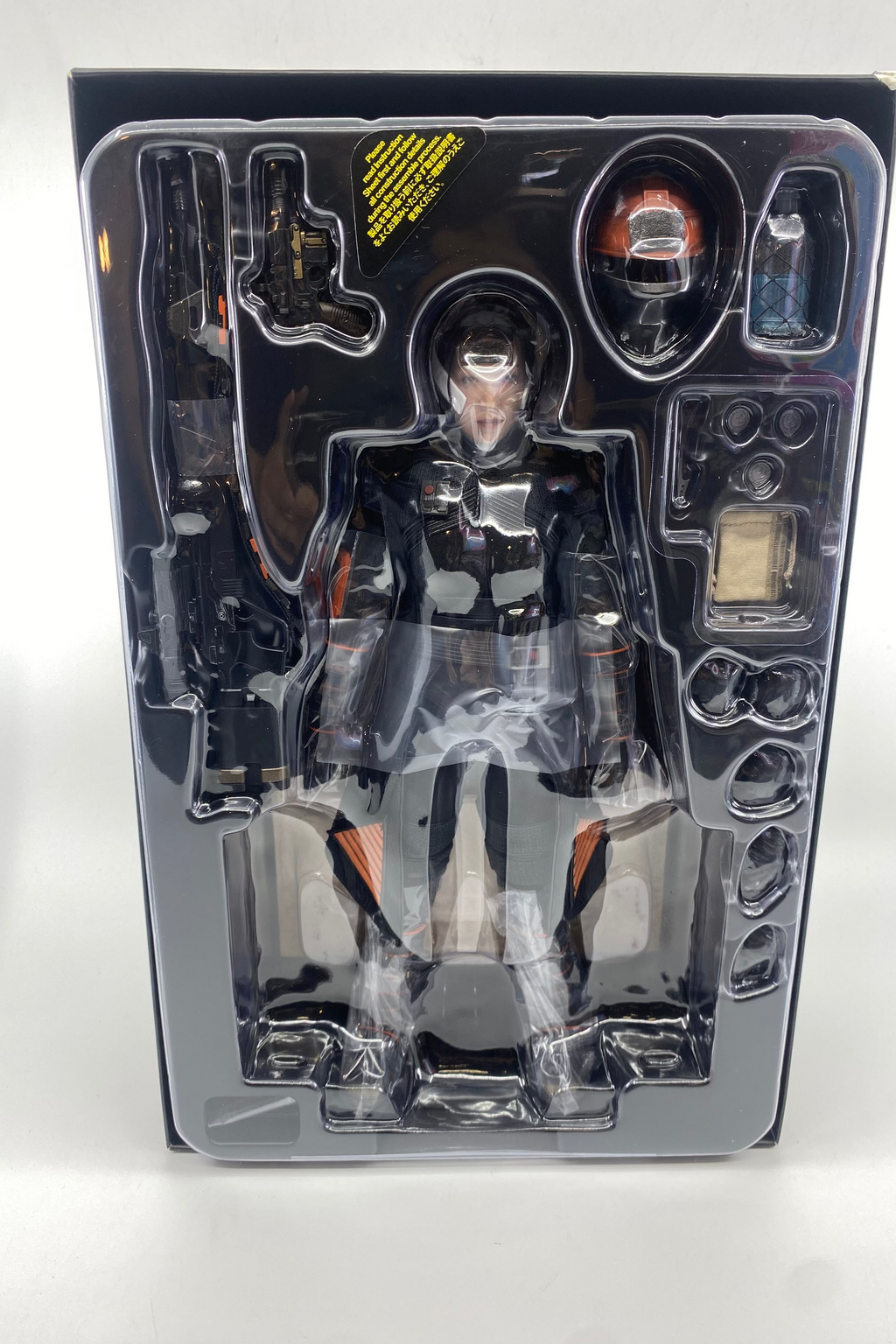 Action figure in a transparent packaging case on a white background