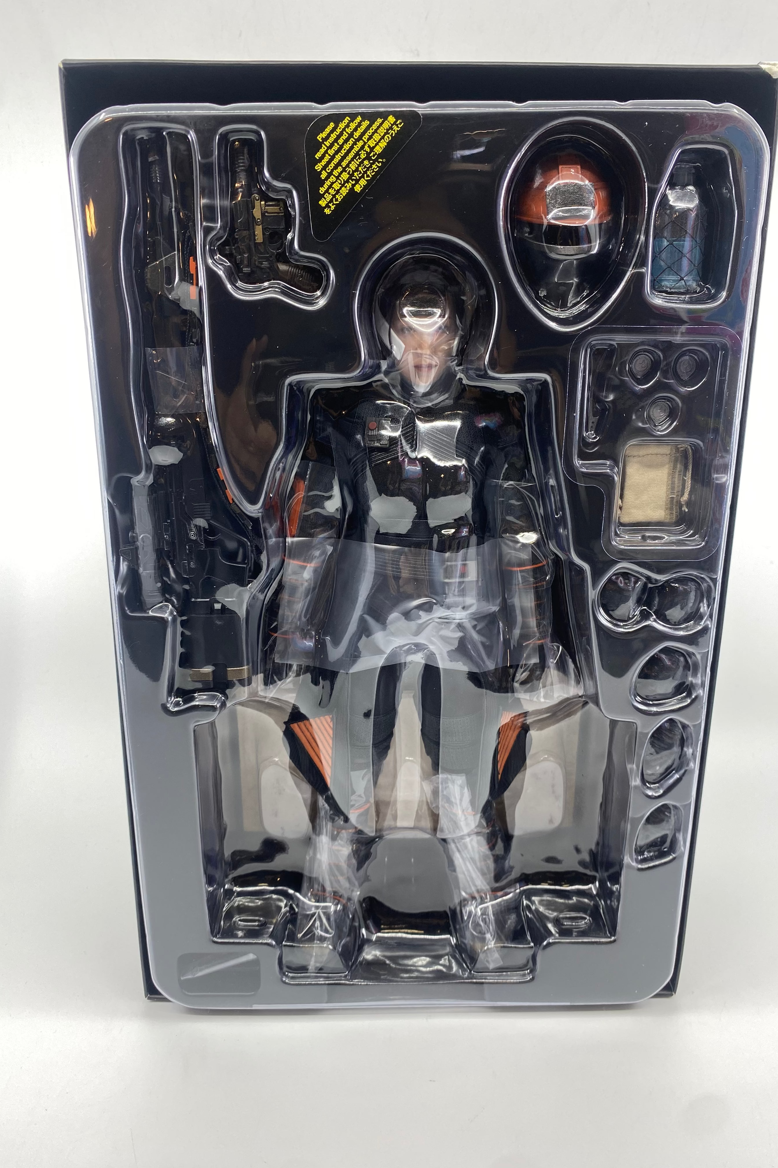 Action figure in a transparent packaging case on a white background