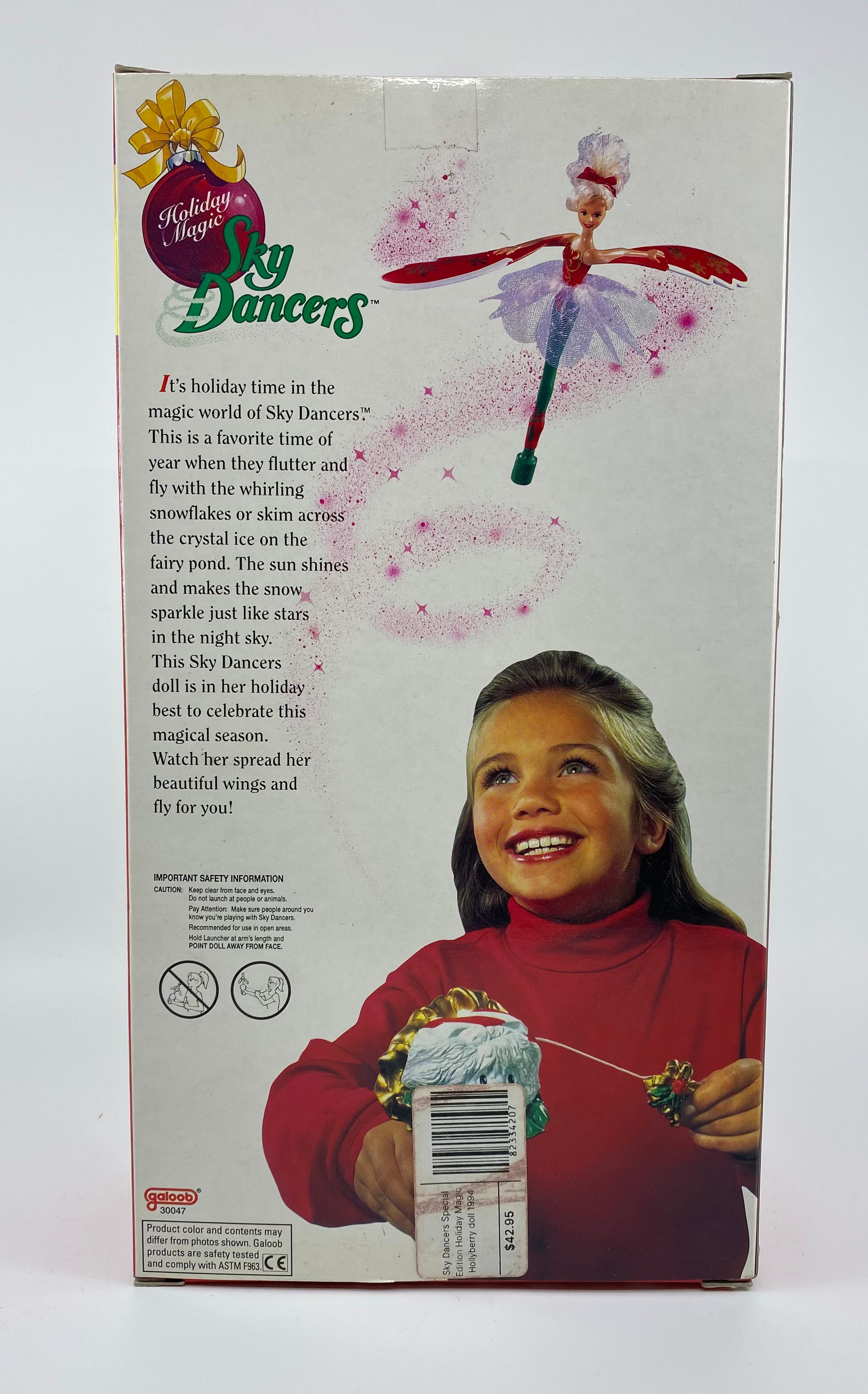 Box of Sky Dancers doll with a girl holding a gift and text on a white background