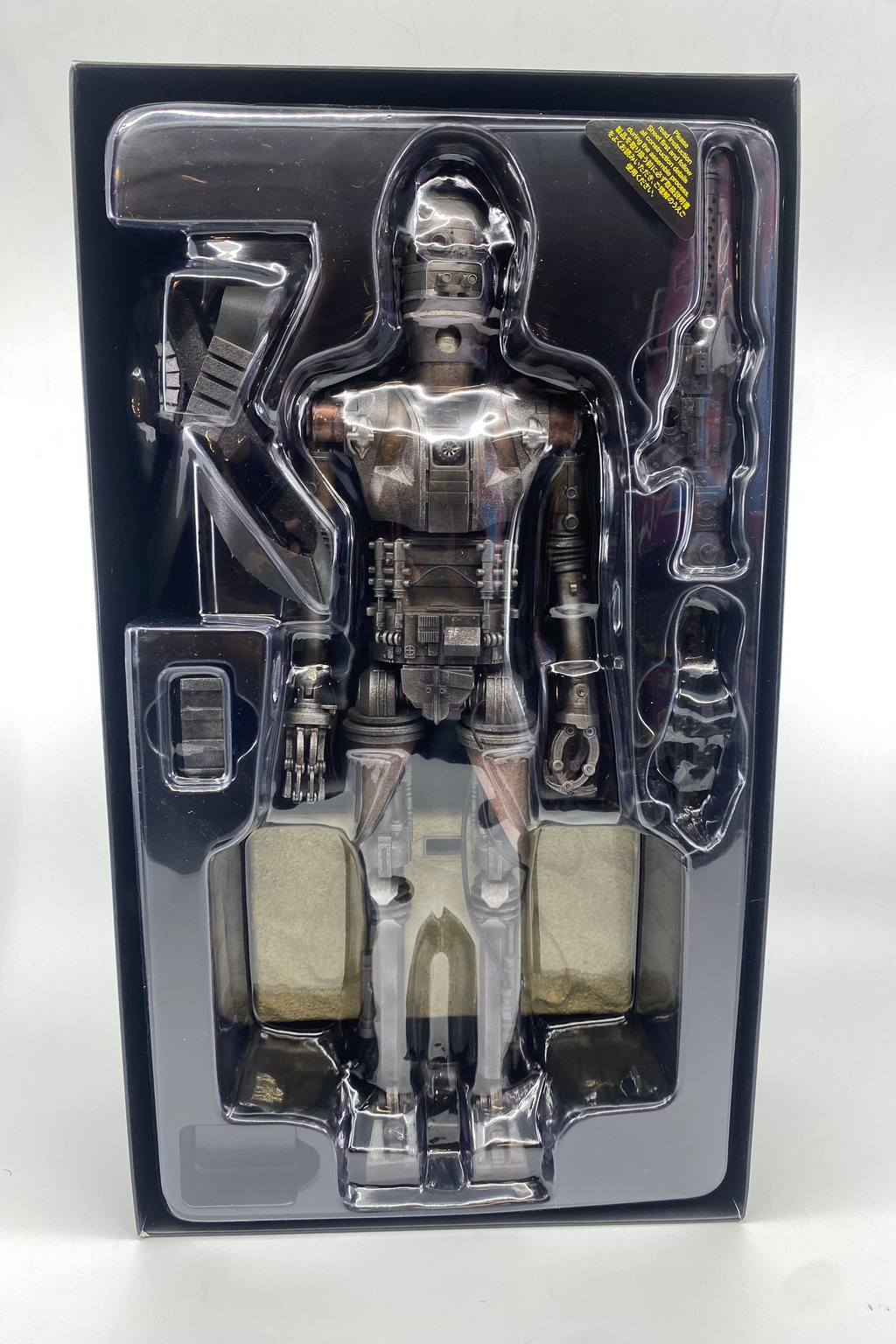 Robot toy figure in clear packaging on a white background