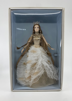 Doll in a decorative box with a white gown and crown on a light gray background