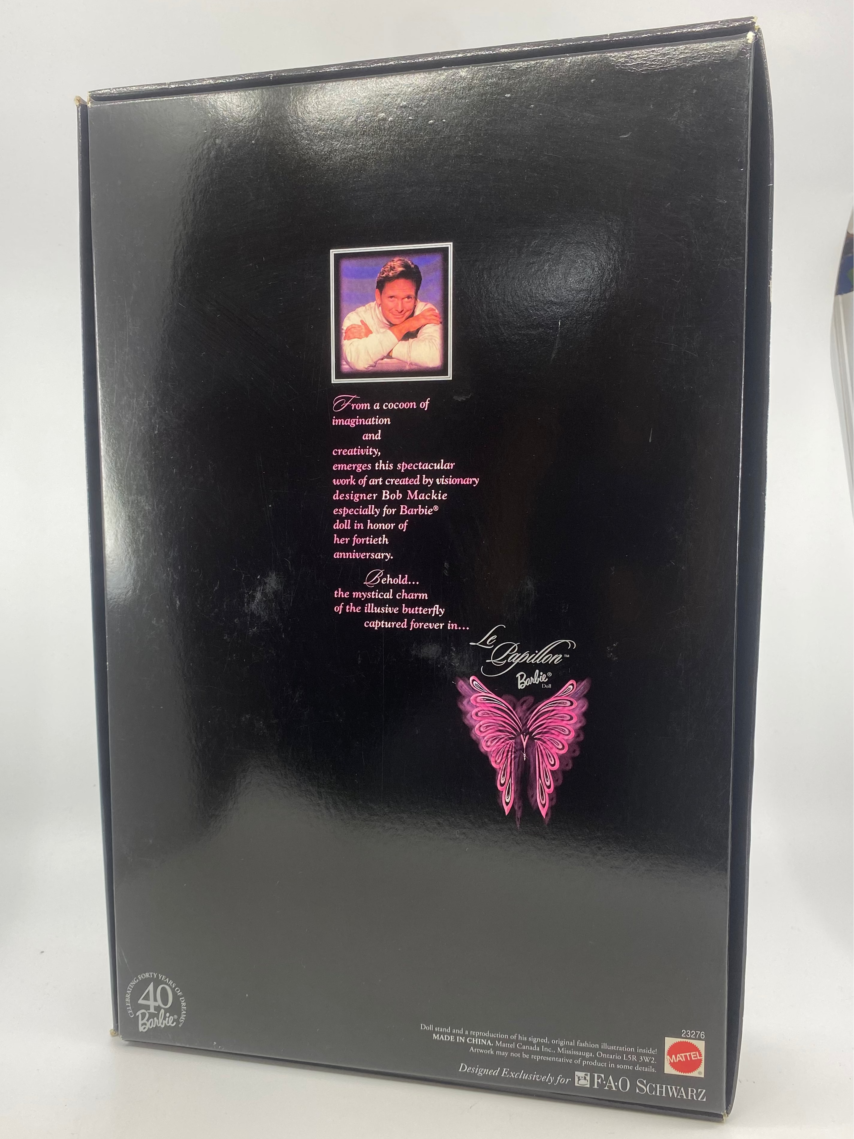 Black box with a butterfly design and text on a white background
