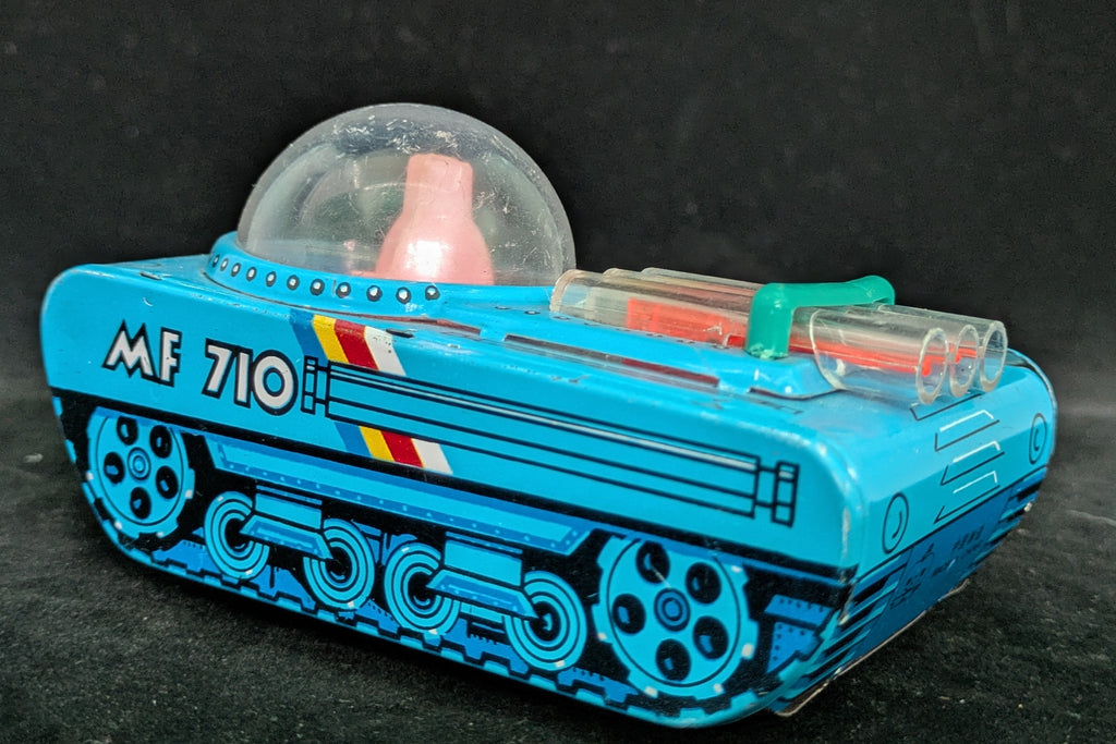 Toy vehicle with a transparent dome on a dark background