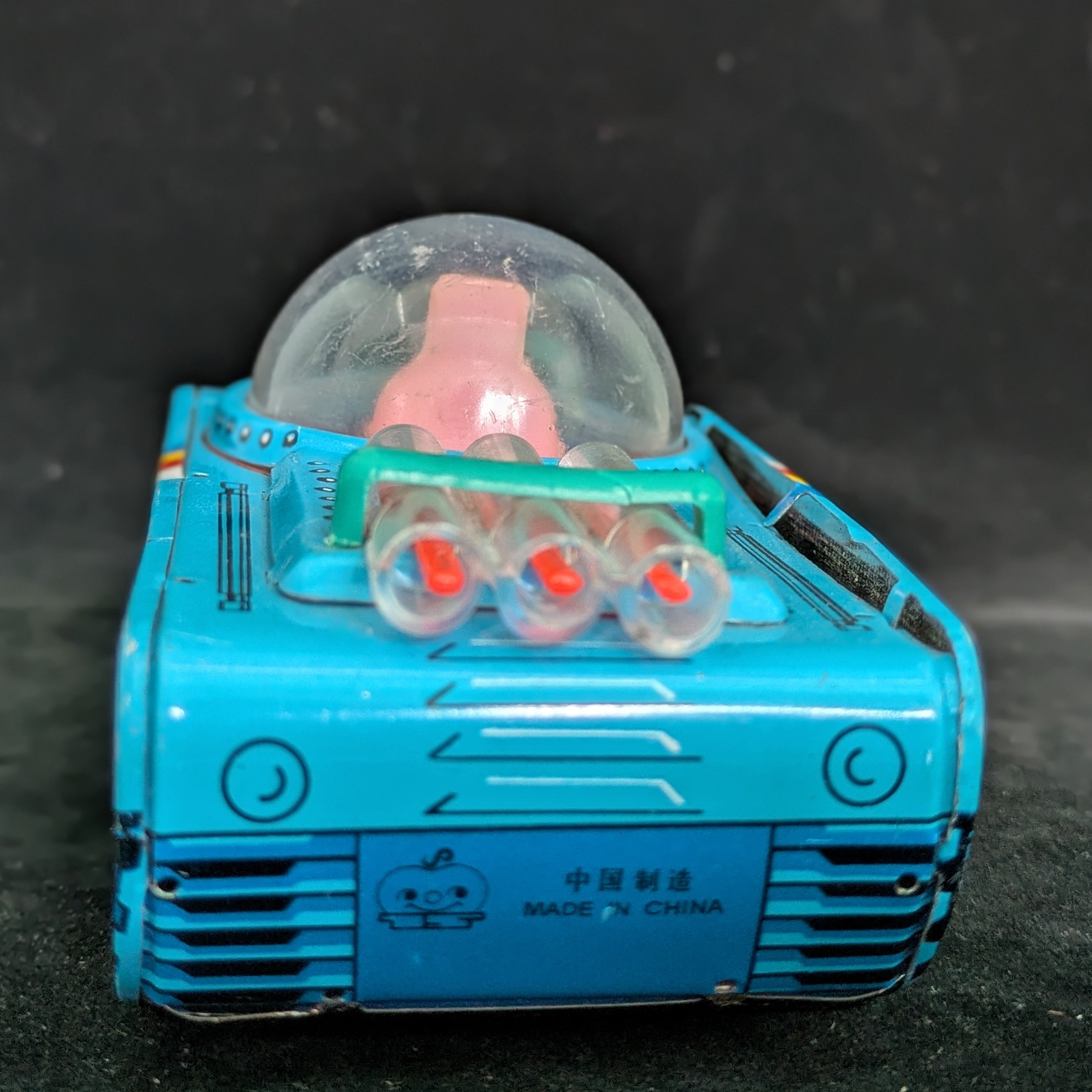Toy robot with a transparent dome on a dark background