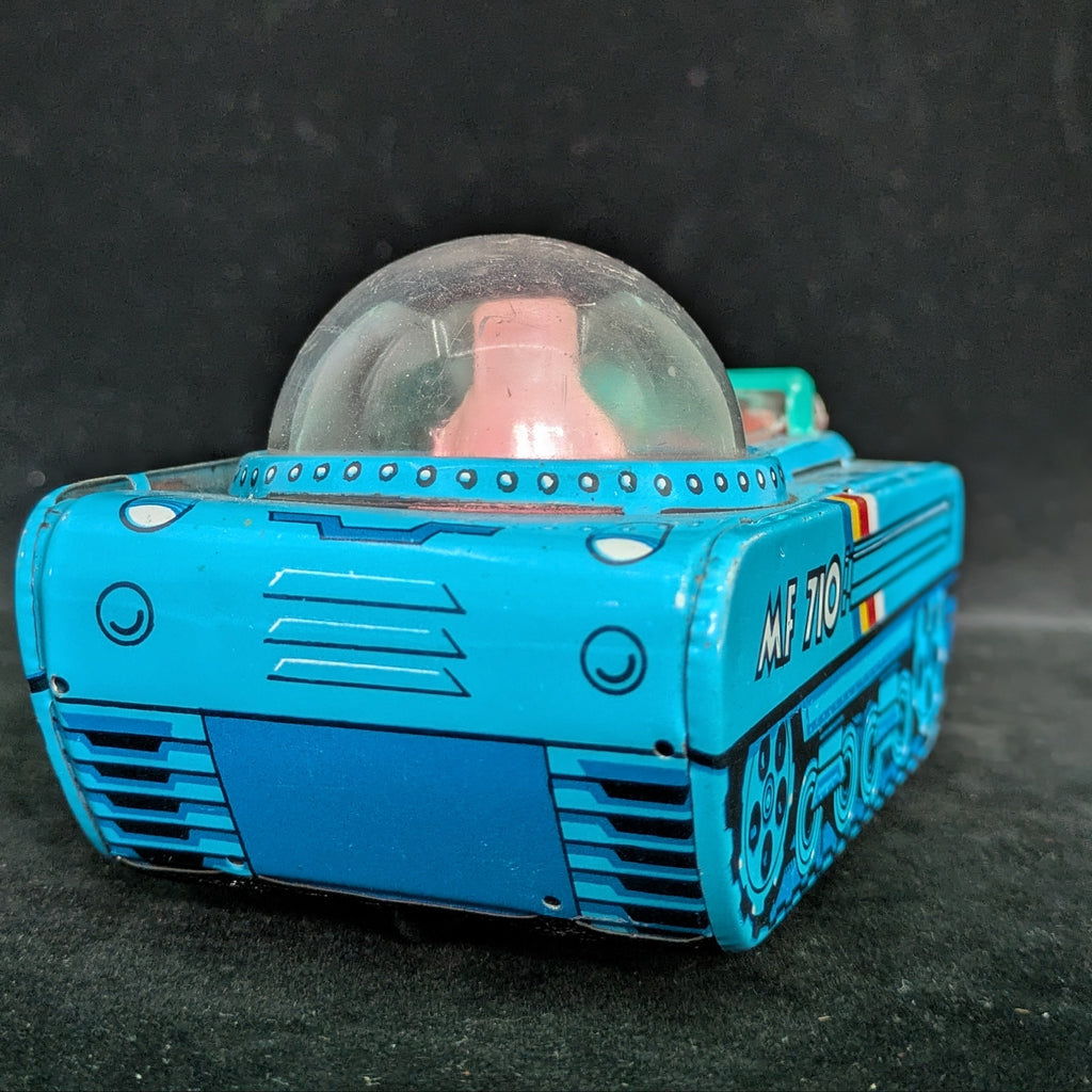 Toy robot with a transparent dome on a dark background