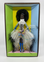 Artistic doll with colorful dress and accessories in a box