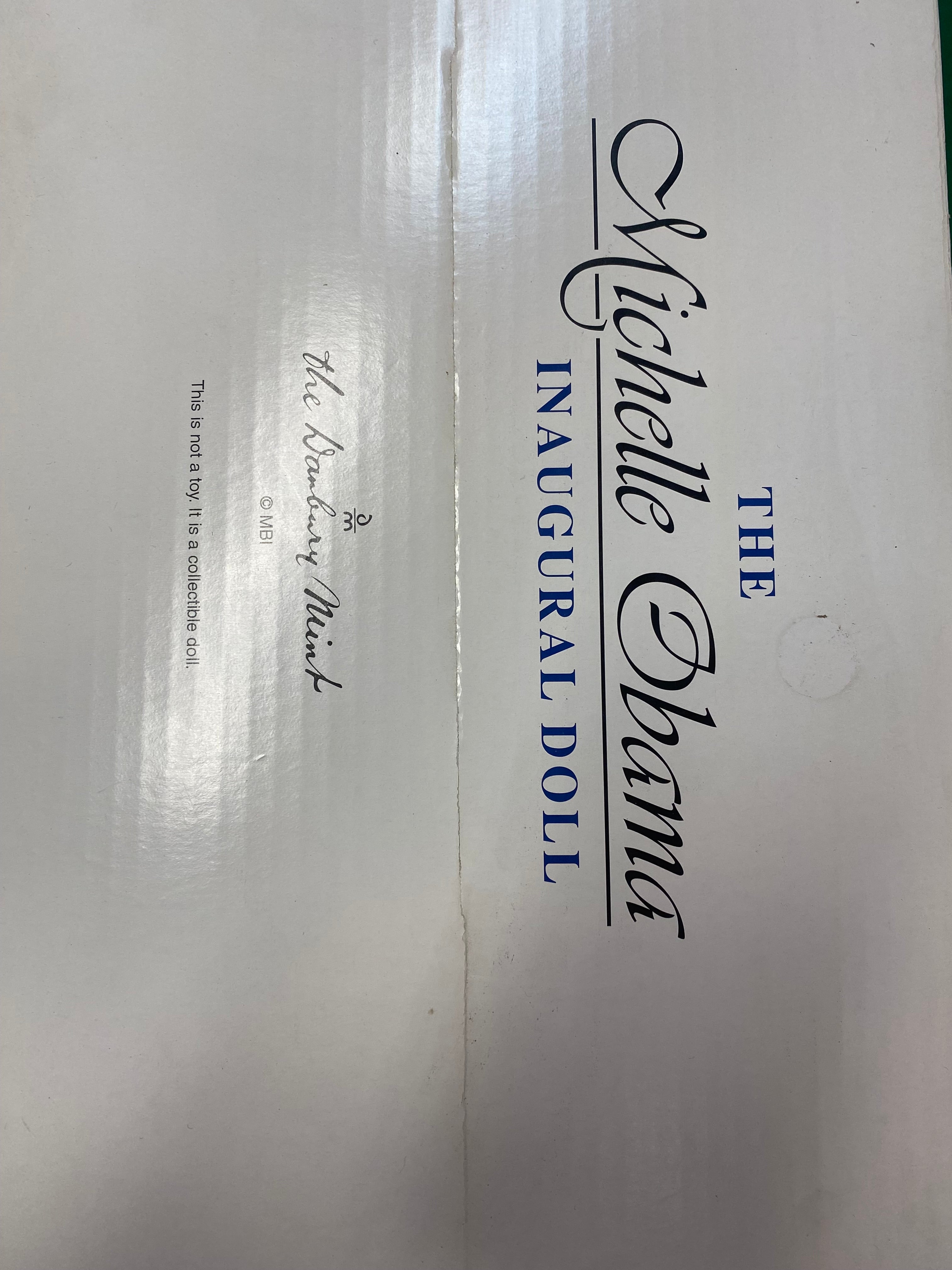 Box for the Michelle Obama Inaugural Doll with branding details.