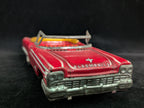 Red toy Oldsmobile car on a black background