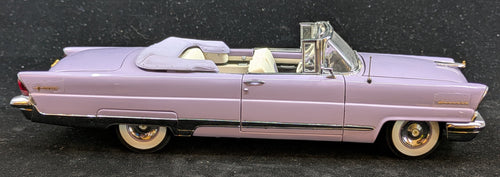Model of a pink vintage car on a dark surface