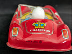Red toy car with 'Champion' branding on a dark background