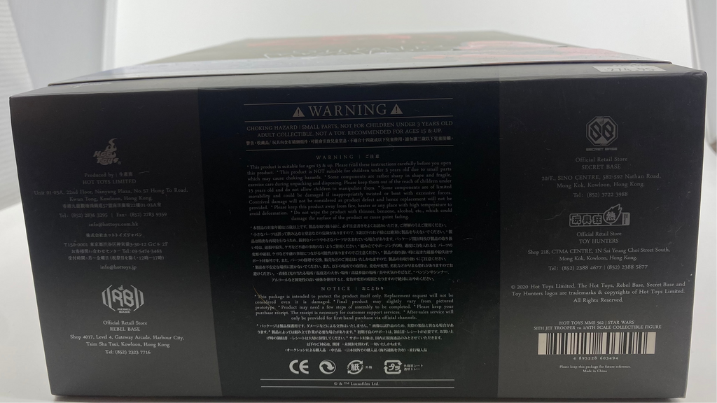 Back view of a gaming console box with text and logos on a white background