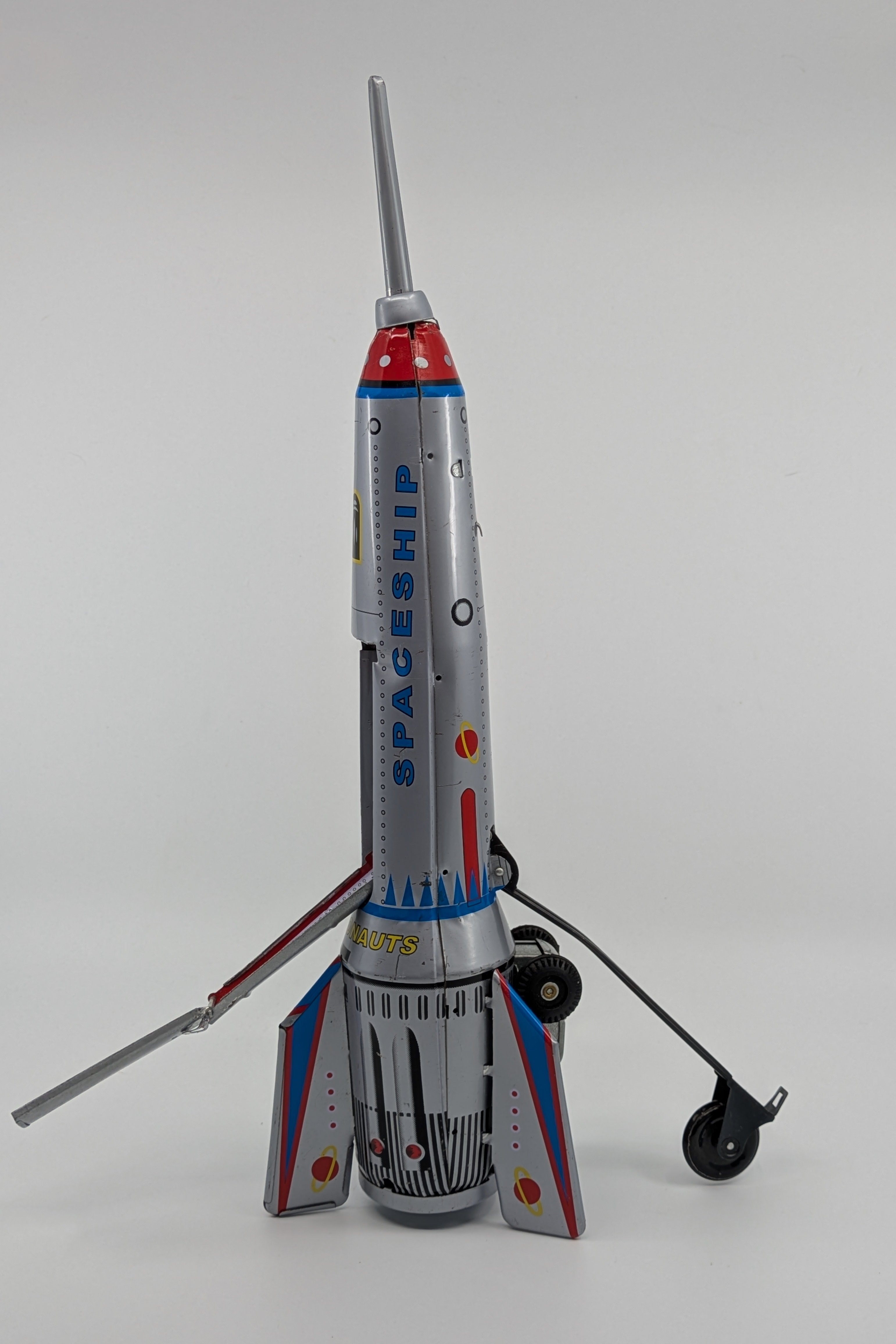 Model of a spaceship with a gray body, red accents, and a white background