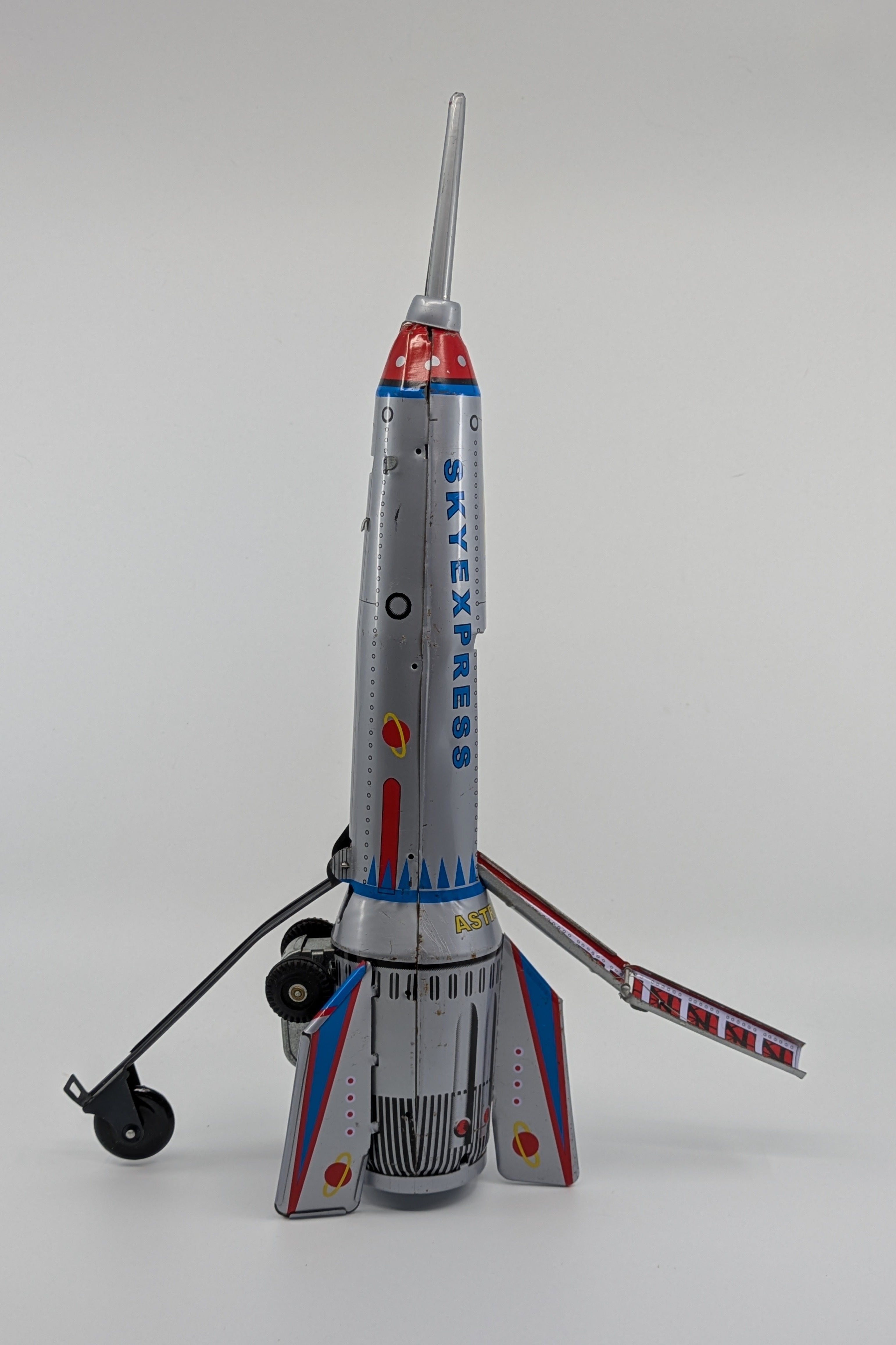 Toy rocket ship with 'Sky Express' branding on a gray background