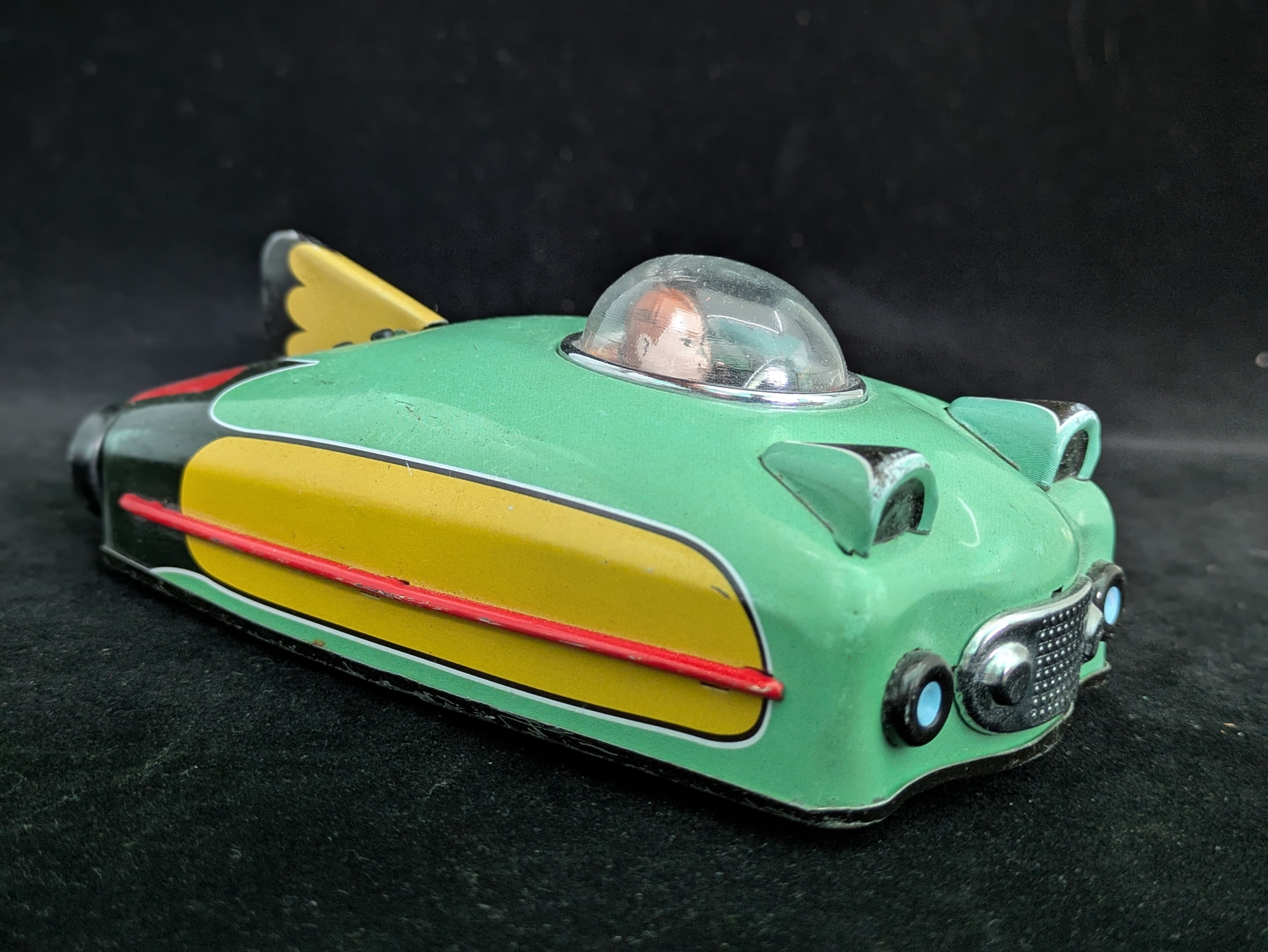 Toy car with a transparent cockpit on a dark background