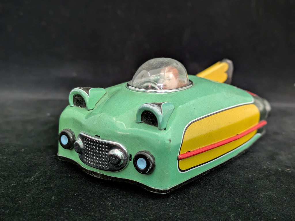 Toy car with a transparent cockpit on a dark background