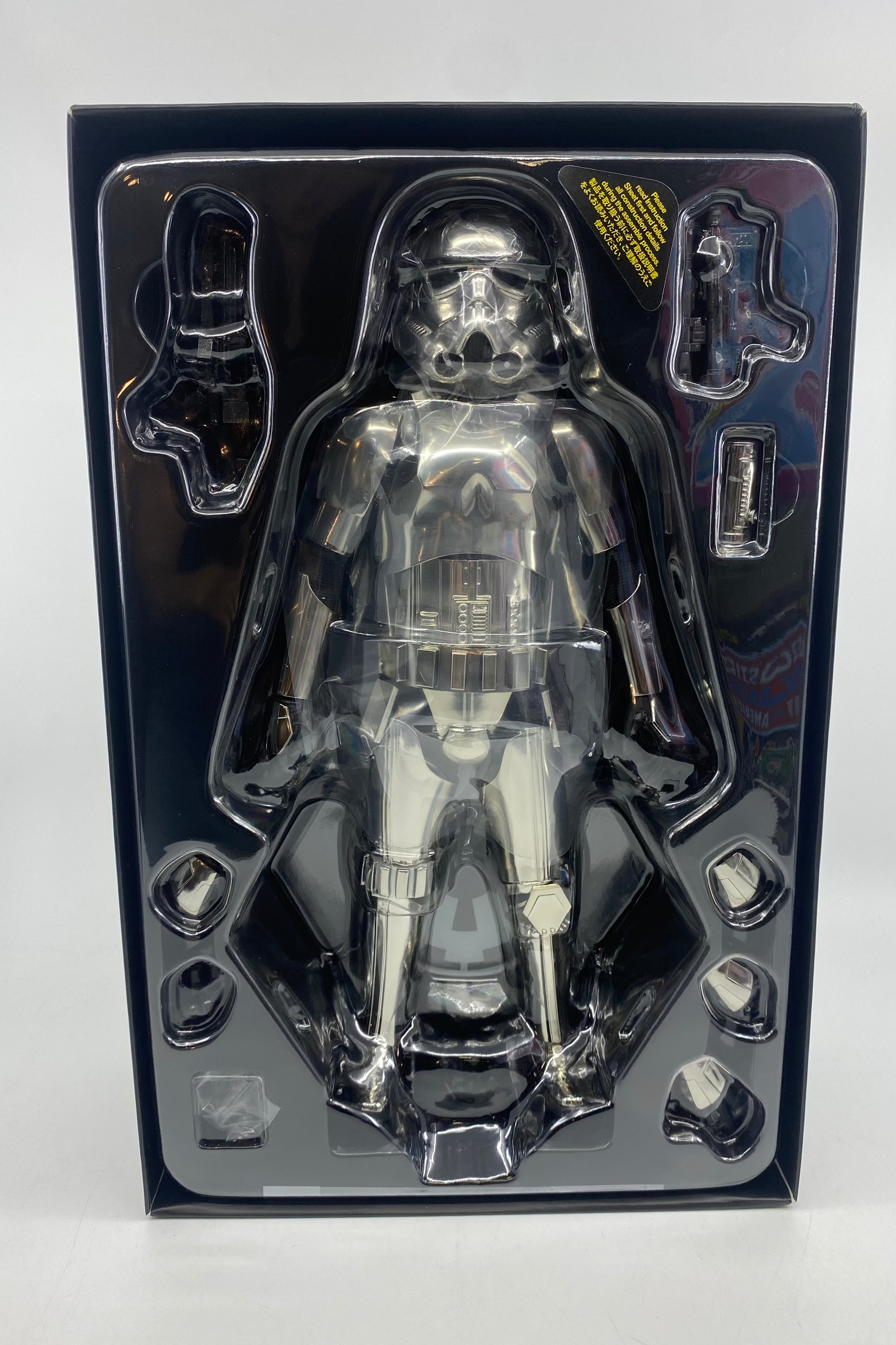 Clear stormtrooper figure in a black packaging case on a white background