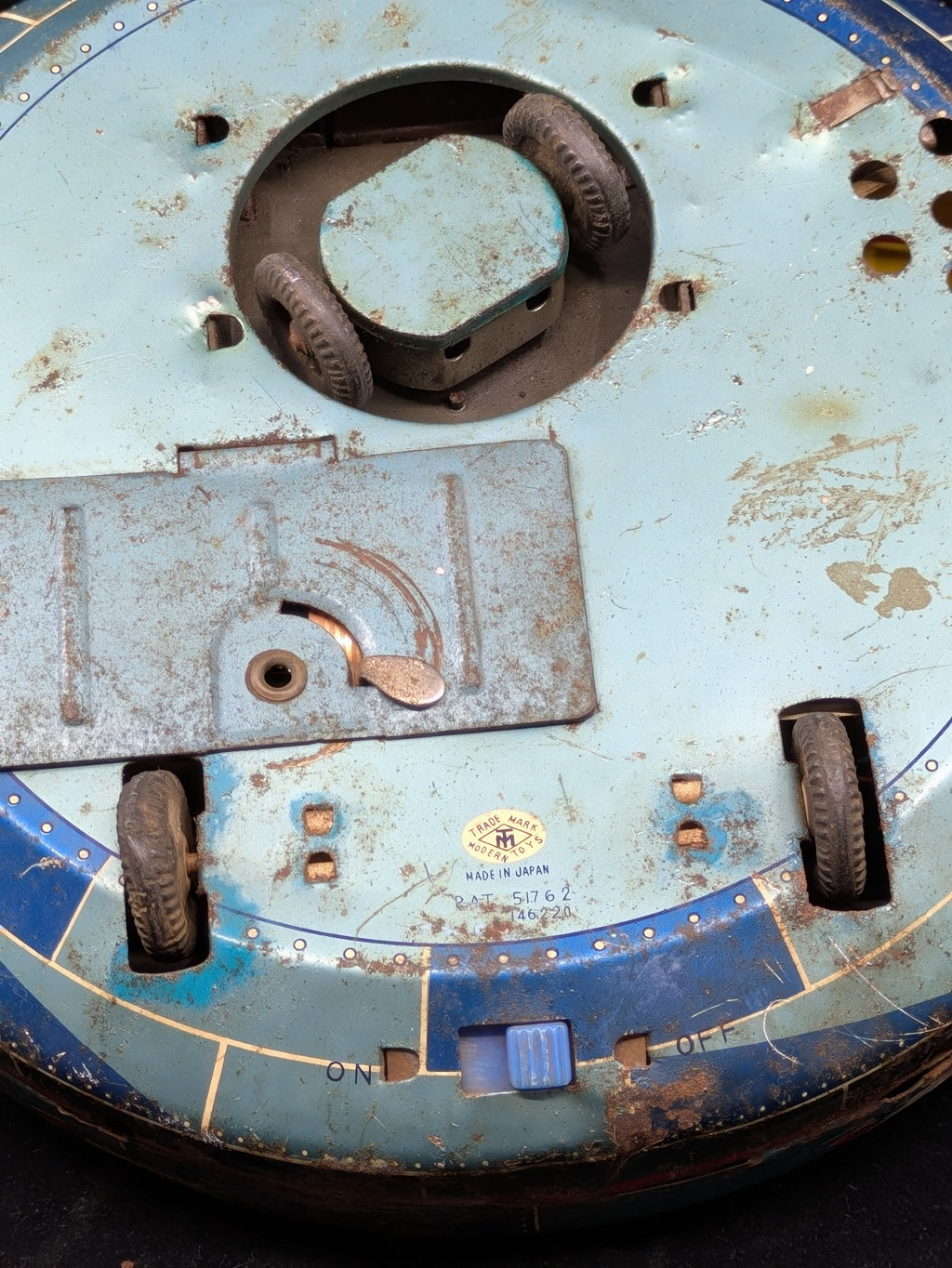 Close-up of a worn-out mechanical component with rust and wear.