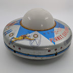 Vintage-style toy UFO with space-themed design on a white background