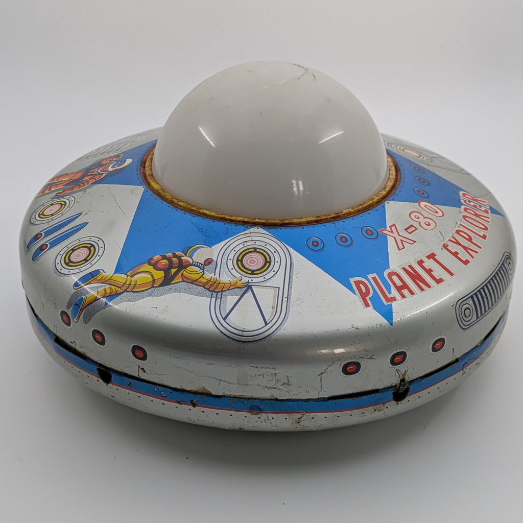 Toy UFO with 'Planet Explorer' text on a white background