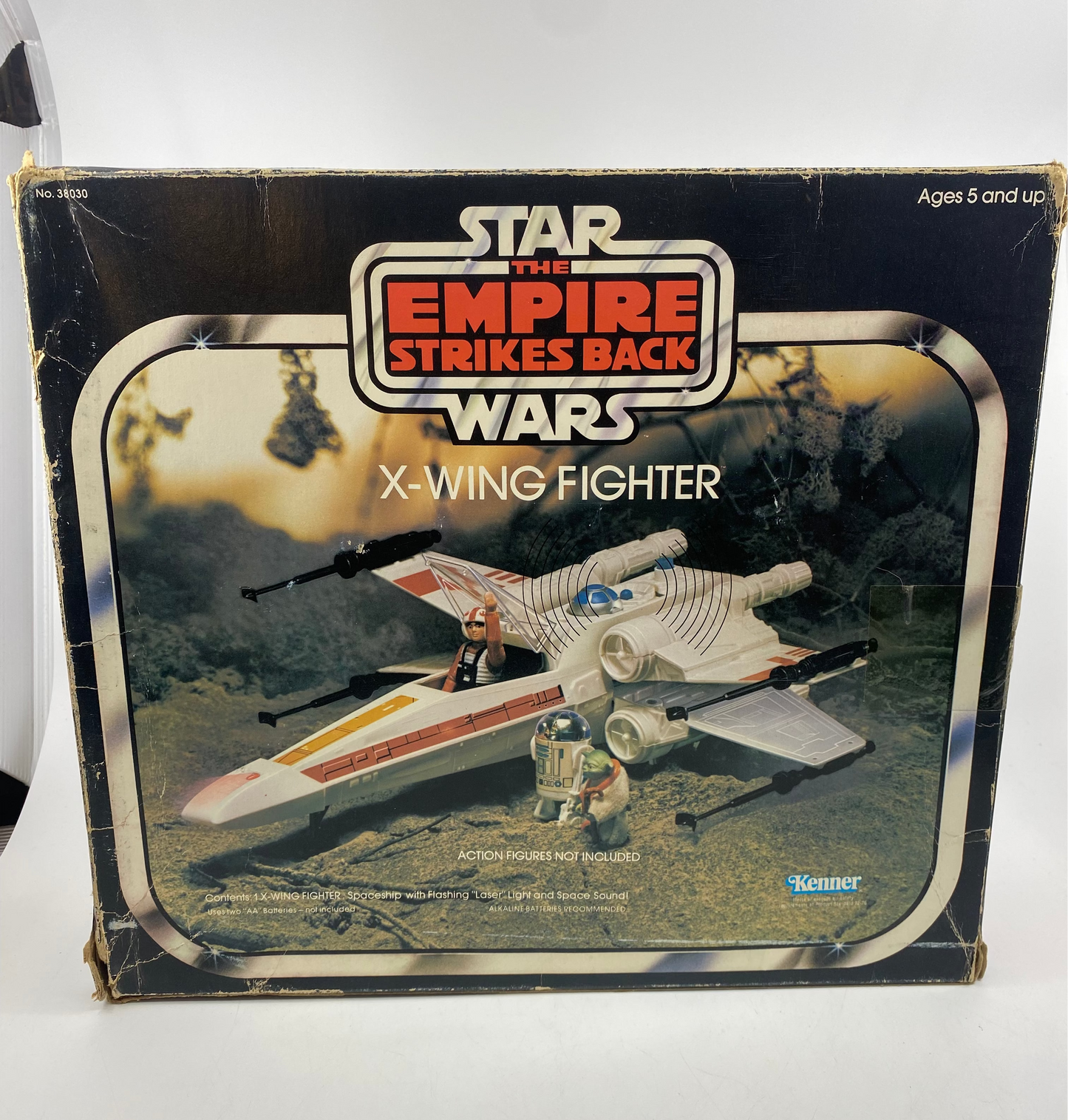 Vintage Star Wars X-Wing Fighter toy box with 'The Empire Strikes Back' logo on a white background.