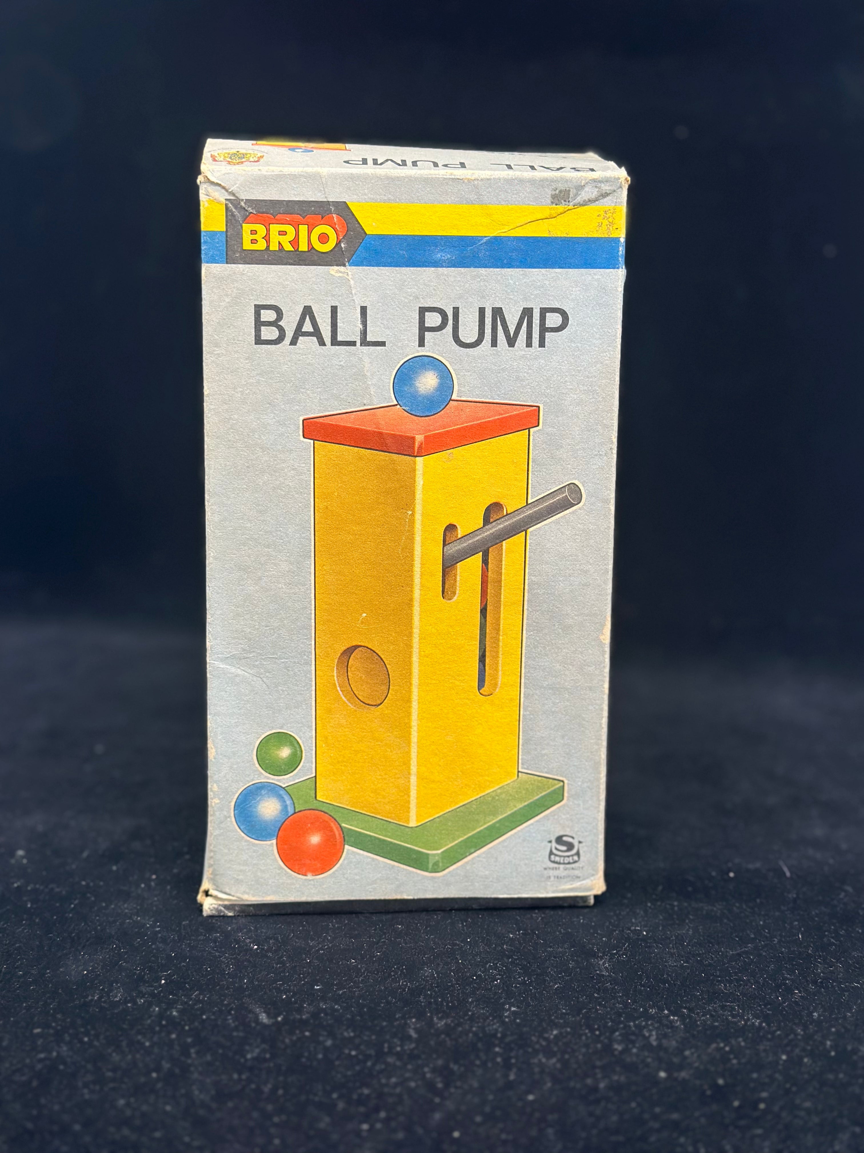 Box of a Brio ball pump on a dark background