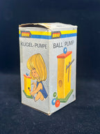 Vintage Brio toy packaging with a child and toy pump illustration on a dark background