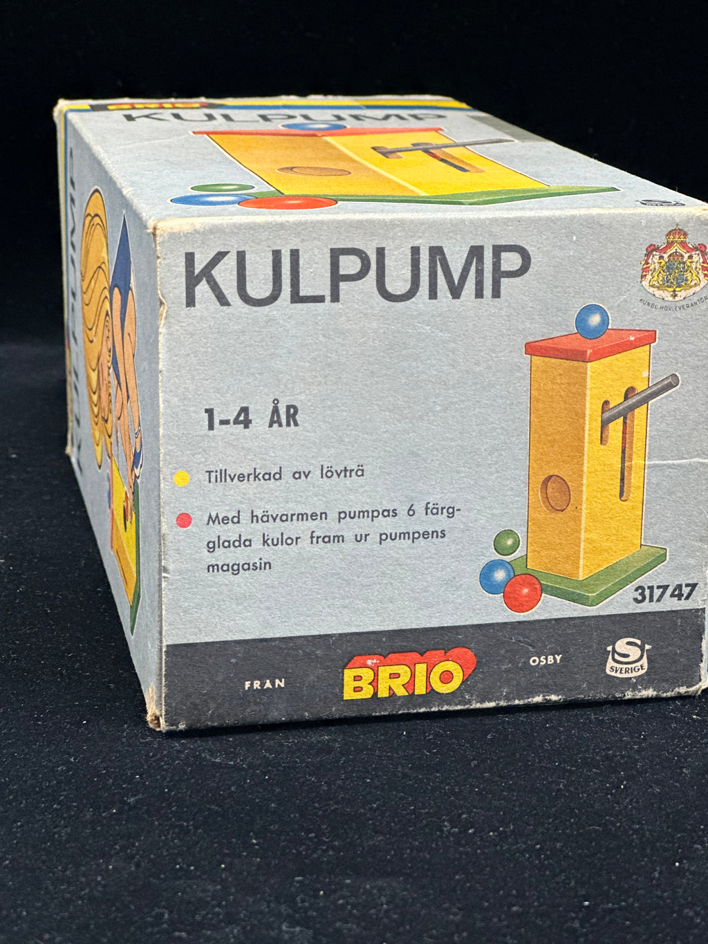 Vintage Brio Kulpump toy box on a black background