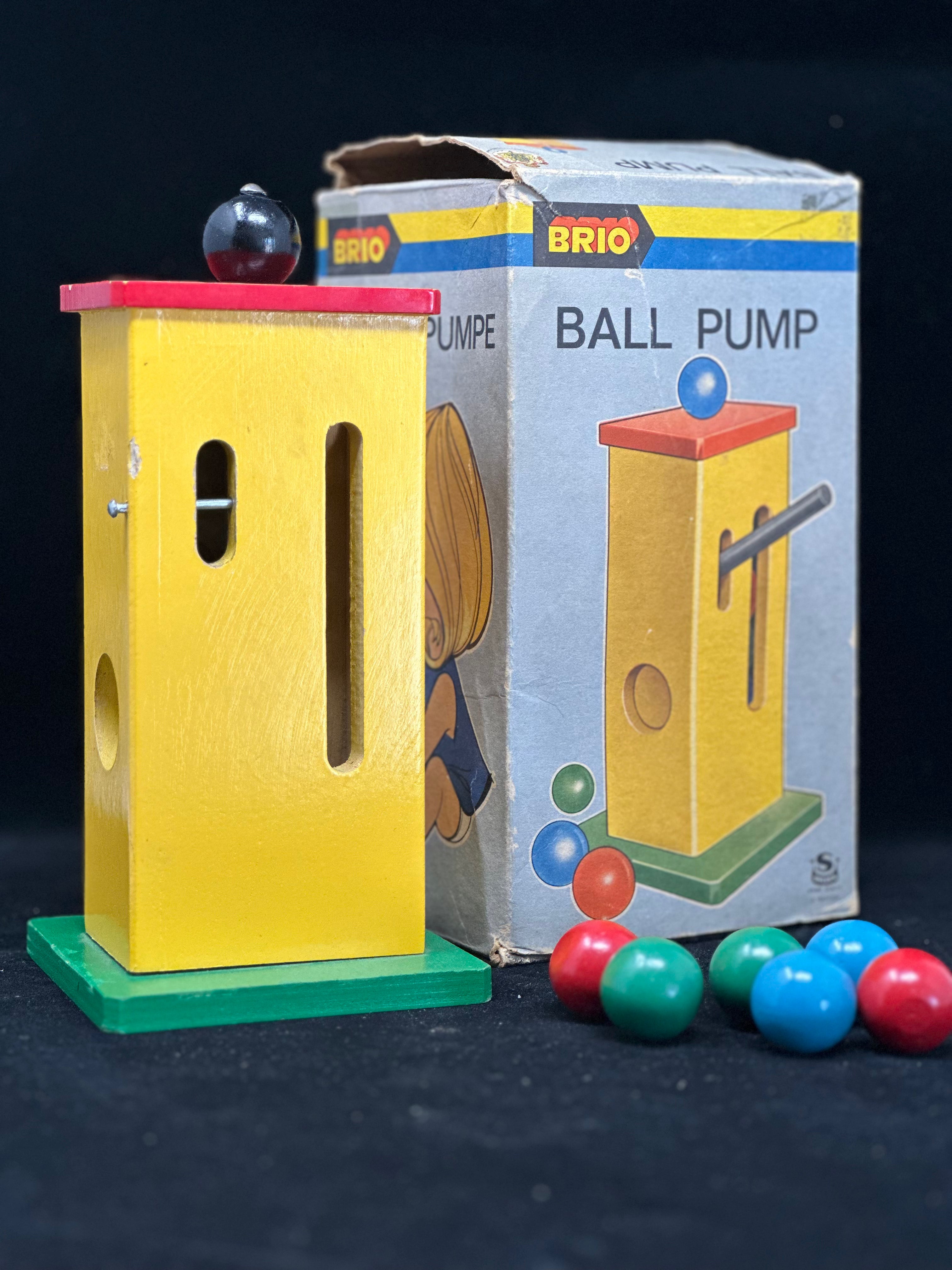 Brio ball pump toy with colorful balls and packaging on a dark background