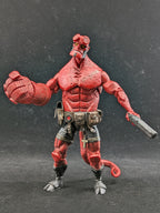 Red action figure with muscular build and weapon on a dark background