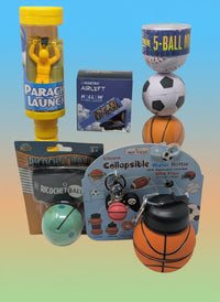 Collection of toys and products including a parachute launch toy, basketball-shaped water bottle, and soccer ball-shaped keychain on a white background.