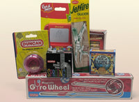 Collection of vintage toys and games with colorful packaging on a white background