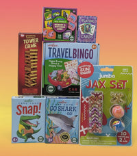 Collection of children's games and toys including a tower game, travel bingo, and card sets.